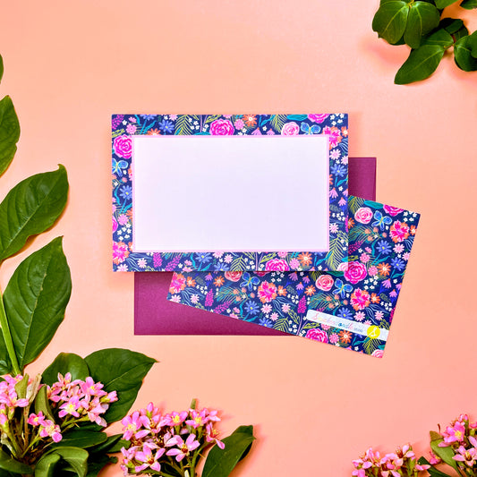 The Summer Night Floral pattern shows beautifully calm, but bright florals on a deep navy background with a bright blue butterfly. This Stationery set of 10 is perfect for a gentle greeting that still expresses the joy of hope. Shown front and back of card on a deep purple envelope.