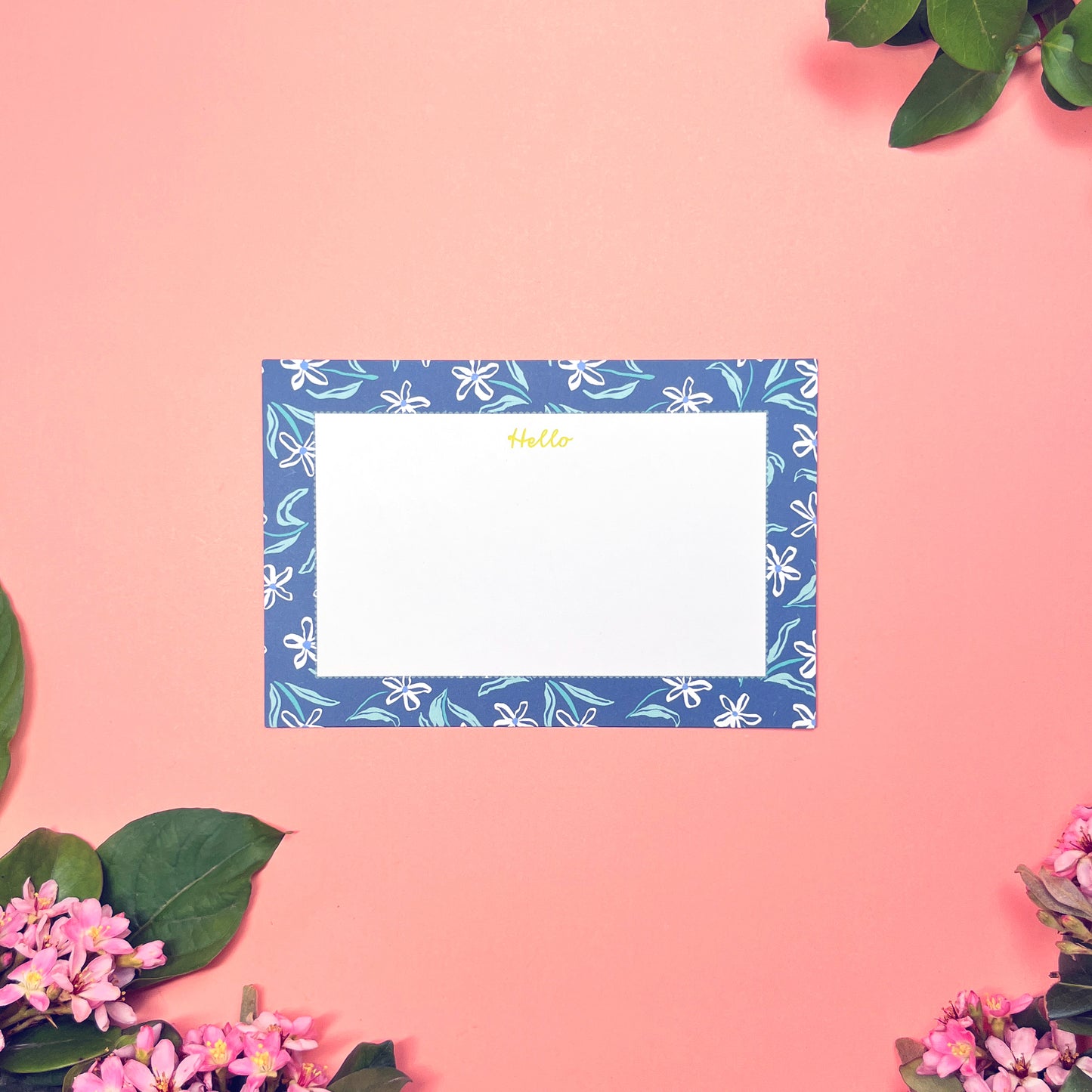 White dainty flower pattern on a blue background with teal and periwinkle accents. Stationery set of 10 with envelopes. Greeting says "Hello" in lime green. Front of card shown by itself.