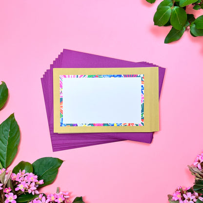 Bright floral pattern in a retro olive- lime border flat note card with a bright stripped back. Perfect for a warm and fu way to send a correspondence.Shown on a stack magenta envelope.
