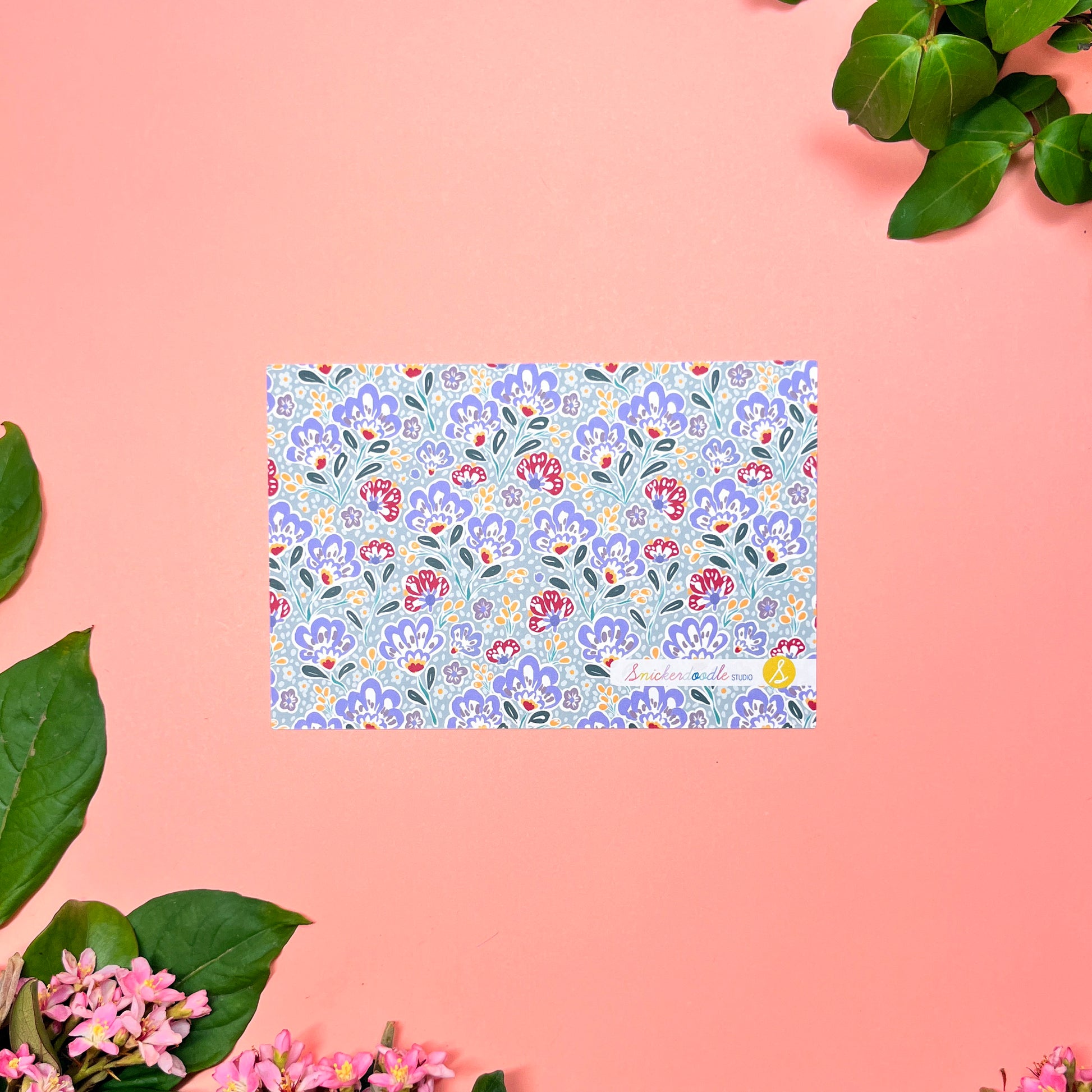 Silver blue paisley floral patterned back of flat note card.