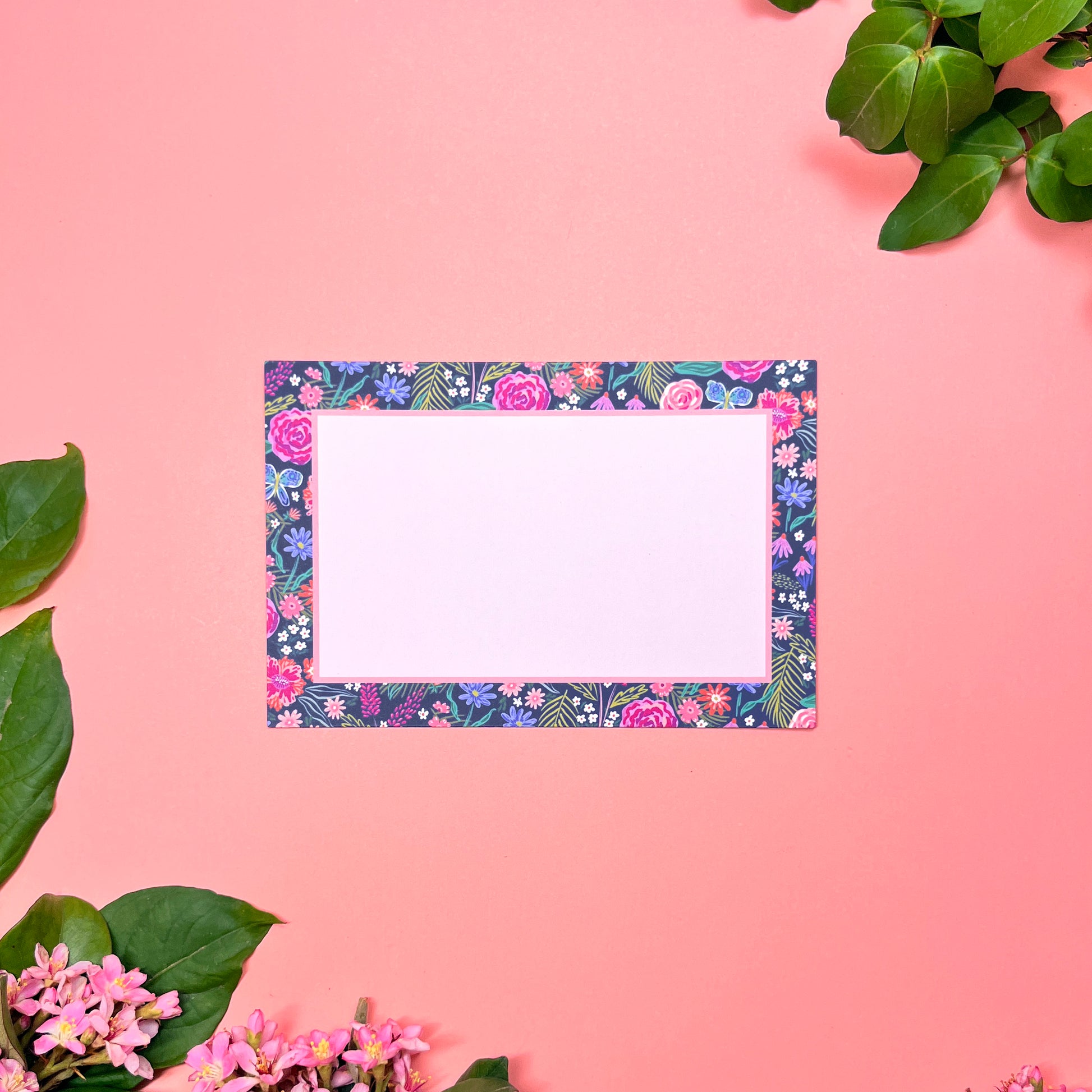 The Summer Night Floral pattern shows beautifully calm, but bright florals on a deep navy background with a bright blue butterfly. Front of card shown by itself.