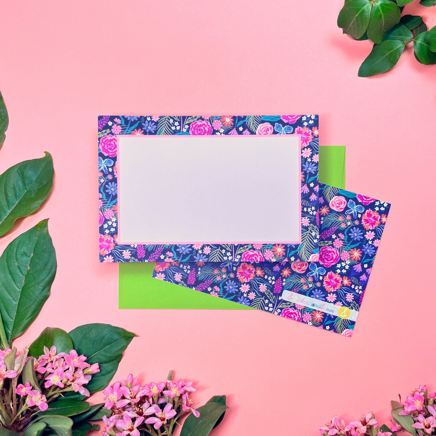 The Summer Night Floral pattern shows beautifully calm, but bright florals on a deep navy background with a bright blue butterfly. This Stationery set of 10  is perfect for a gentle greeting that still expresses the joy of hope. Shown front and back of card on a lime envelope.
